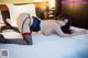 A woman laying on top of a bed in a hotel room.