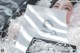 A woman laying on top of a bed covered in shredded paper.